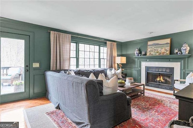 living room with crown molding and hardwood / wood-style floors