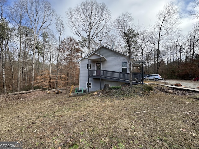 view of side of home featuring a wooden deck