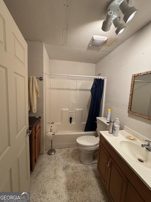 full bathroom featuring shower / bath combination with curtain, vanity, and toilet