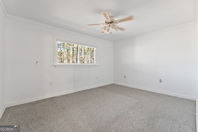 carpeted spare room with crown molding and ceiling fan