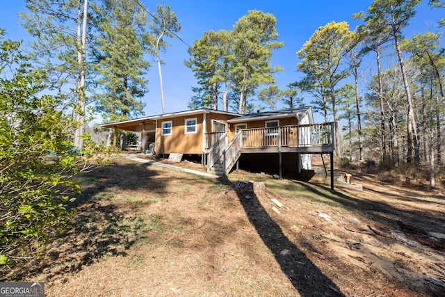 back of house featuring a wooden deck