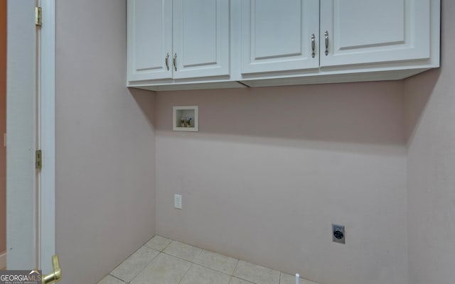 laundry room featuring light tile patterned floors, cabinet space, hookup for a washing machine, and electric dryer hookup