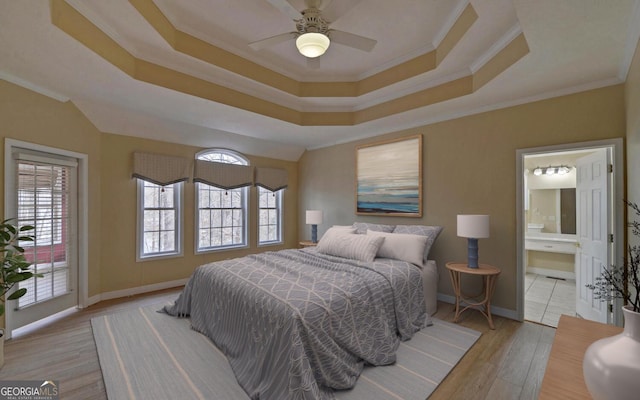 bedroom with a raised ceiling, light wood-style floors, ornamental molding, access to outside, and baseboards