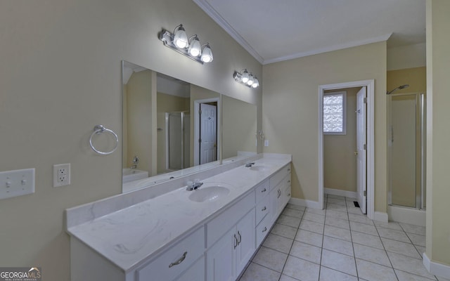 bathroom with ornamental molding, a garden tub, a sink, and a shower stall