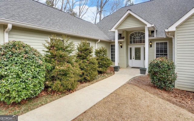 property entrance with roof with shingles