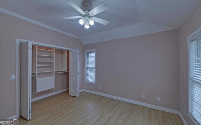 unfurnished bedroom with lofted ceiling, baseboards, and light wood finished floors