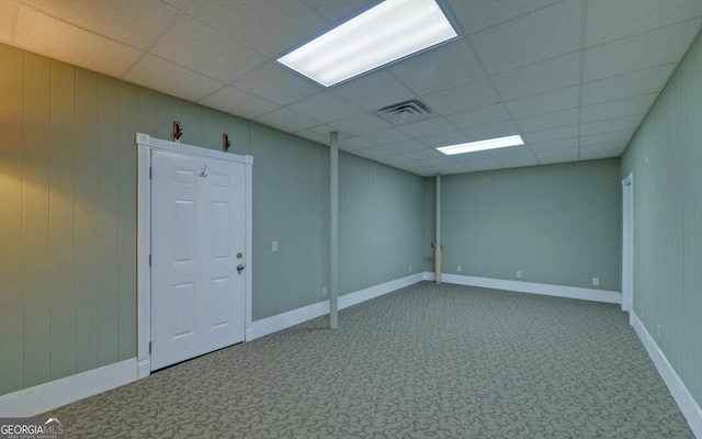 unfurnished room featuring carpet floors, a drop ceiling, visible vents, and baseboards