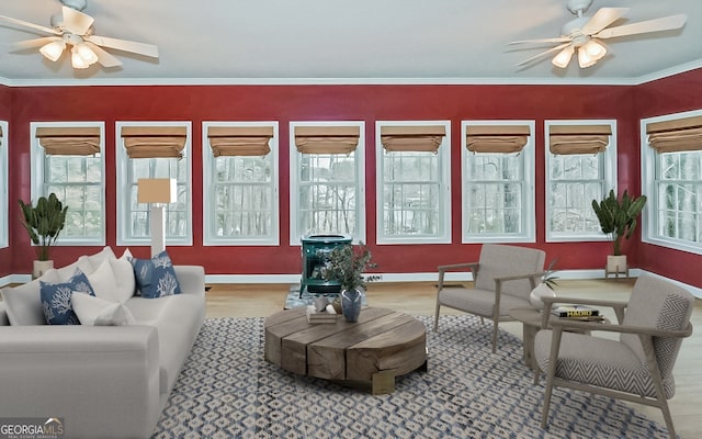 sunroom / solarium featuring ceiling fan