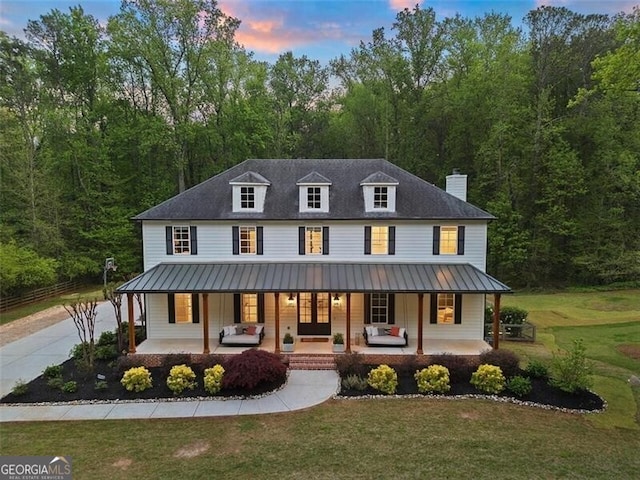 view of front facade with a porch and a yard