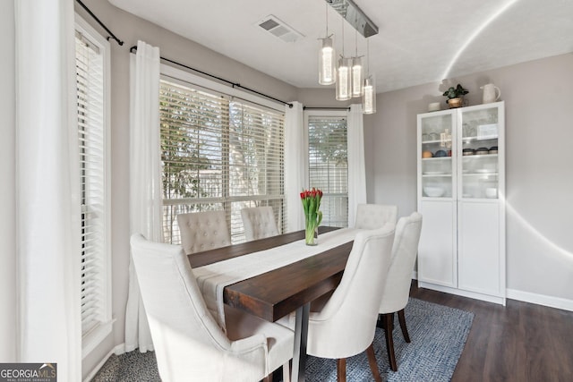 dining space with dark wood-type flooring