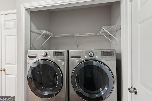 laundry room featuring washing machine and clothes dryer