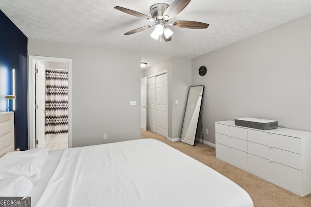 bedroom with ceiling fan, light carpet, and a textured ceiling