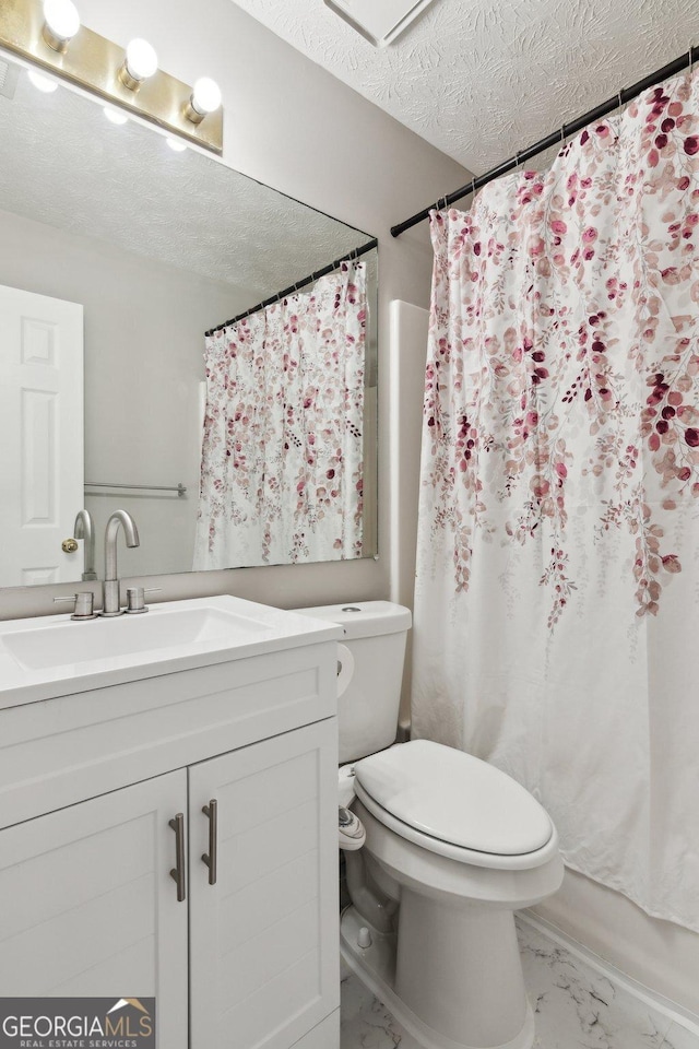 full bathroom with vanity, toilet, a textured ceiling, and shower / tub combo with curtain