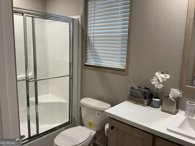 full bathroom with vanity, combined bath / shower with glass door, and toilet