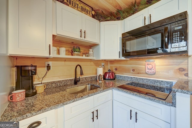 kitchen featuring white cabinetry, sink, black appliances, and light stone countertops