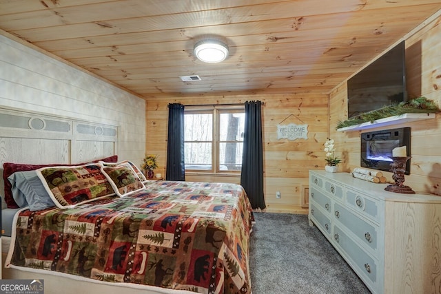 bedroom with wood walls, carpet floors, and wooden ceiling