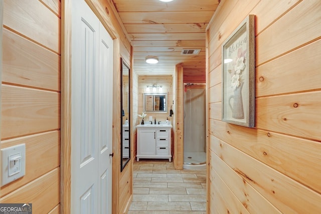 hall with wooden ceiling and wooden walls