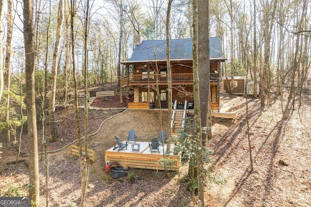 back of house with a wooden deck