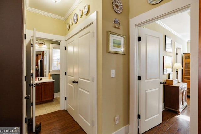 corridor featuring ornamental molding and dark hardwood / wood-style flooring