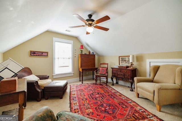 sitting room with ceiling fan, light colored carpet, and vaulted ceiling