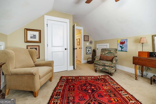 living area featuring lofted ceiling, light colored carpet, and ceiling fan