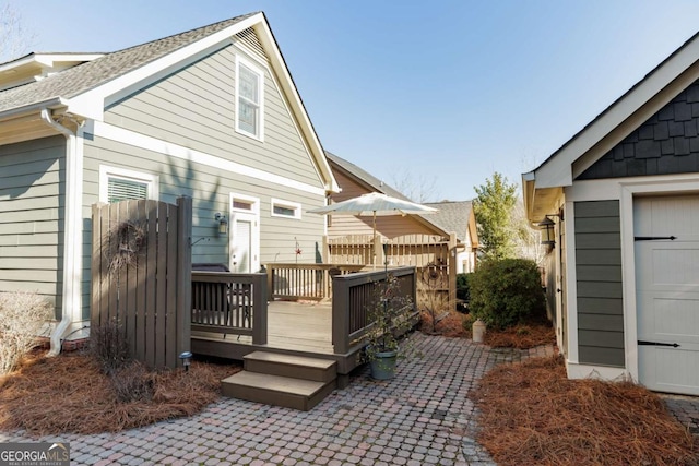 back of property featuring a deck