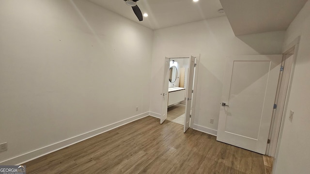 interior space featuring hardwood / wood-style flooring and ensuite bath