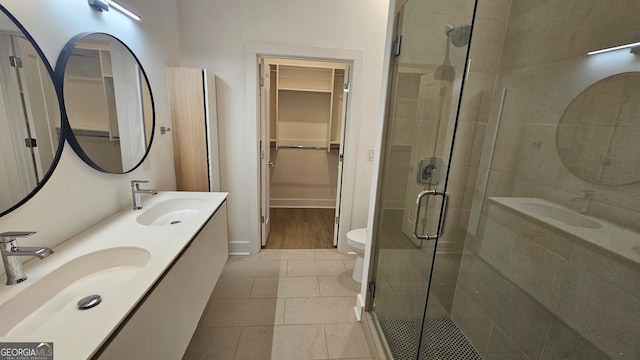 bathroom featuring vanity, toilet, and an enclosed shower