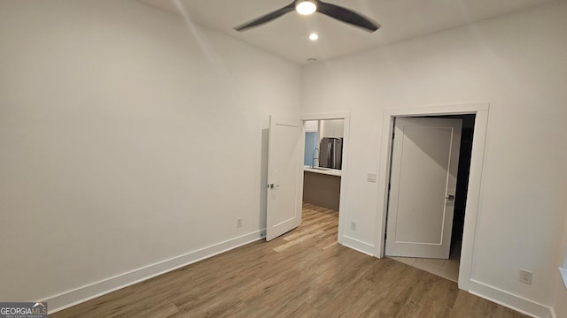 empty room with wood-type flooring and ceiling fan