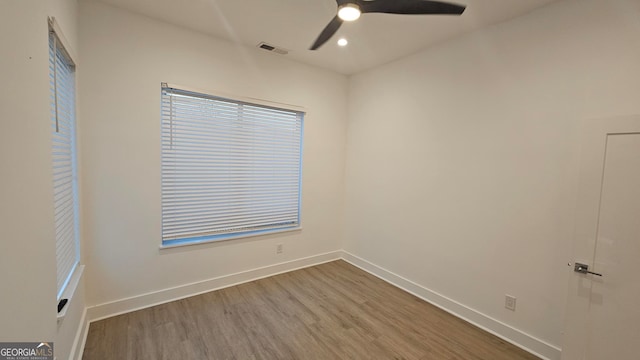 spare room with hardwood / wood-style flooring and ceiling fan