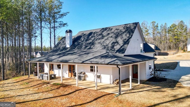 exterior space with a front lawn and a patio