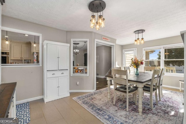 dining room featuring a notable chandelier and a textured ceiling