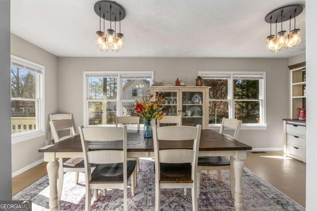 dining space with tile patterned floors and a chandelier