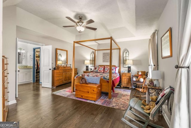 bedroom featuring dark hardwood / wood-style flooring and a textured ceiling