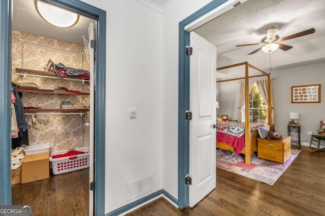 bedroom featuring crown molding and dark wood-type flooring