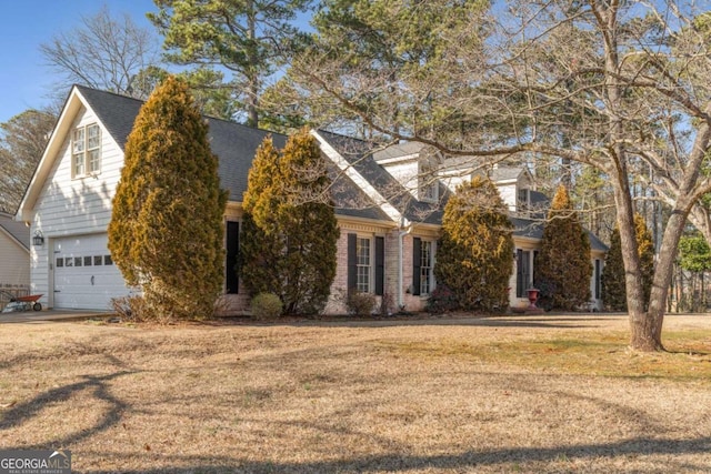 view of front facade with a garage and a front lawn