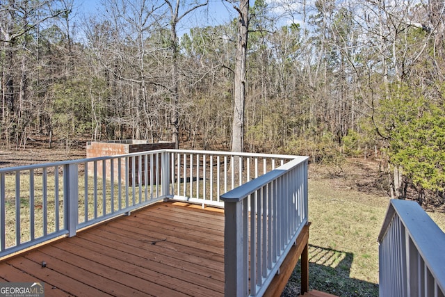 wooden deck with a lawn