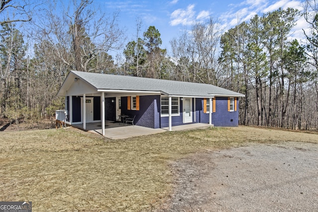 single story home with a patio and a front yard