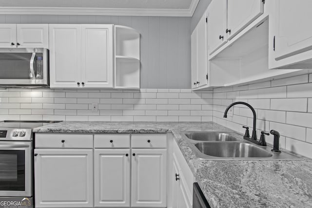 kitchen with sink, crown molding, appliances with stainless steel finishes, decorative backsplash, and white cabinets