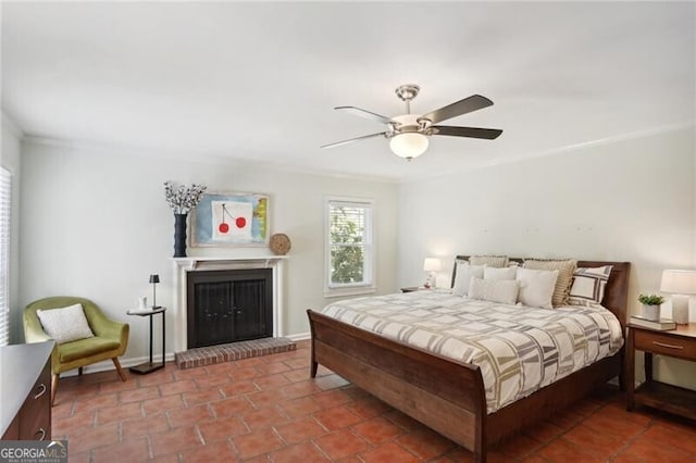 tiled bedroom featuring a fireplace and ceiling fan