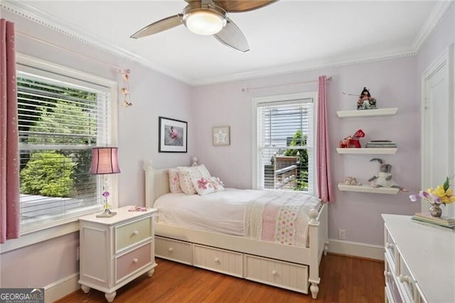 bedroom with crown molding, ceiling fan, and dark hardwood / wood-style floors