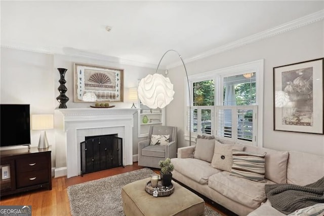 living room with ornamental molding and light hardwood / wood-style flooring