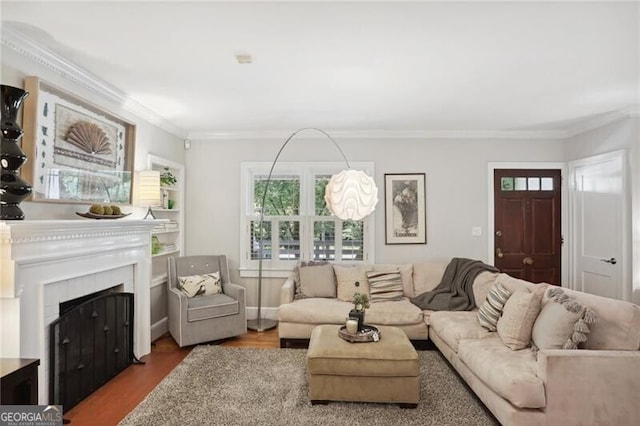 living room featuring hardwood / wood-style flooring and ornamental molding