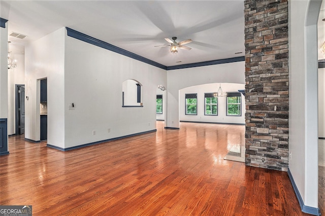 2753 Jubilee Ter, Bethlehem, GA 30620 - unfurnished living room featuring ceiling fan, wood finished floors, a chandelier, arched walkways, and ornamental molding