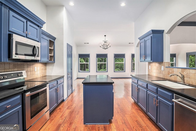 2753 Jubilee Ter, Bethlehem, GA 30620 - kitchen with appliances with stainless steel finishes, dark countertops, a center island, a chandelier, and decorative backsplash