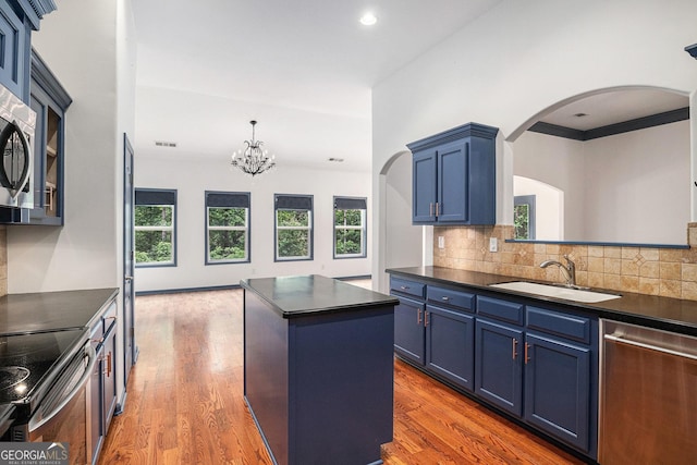 2753 Jubilee Ter, Bethlehem, GA 30620 - kitchen with stainless steel appliances, dark countertops, blue cabinets, arched walkways, and tasteful backsplash