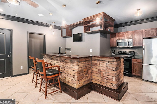 2753 Jubilee Ter, Bethlehem, GA 30620 - kitchen with stainless steel appliances, dark countertops, light tile patterned flooring, crown molding, and decorative light fixtures
