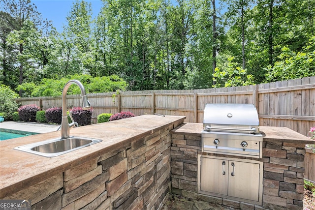 2753 Jubilee Ter, Bethlehem, GA 30620 - view of patio / terrace with an outdoor kitchen and view of scattered trees
