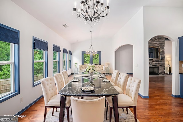2753 Jubilee Ter, Bethlehem, GA 30620 - dining room featuring a chandelier, healthy amount of natural light, arched walkways, wood finished floors, and vaulted ceiling