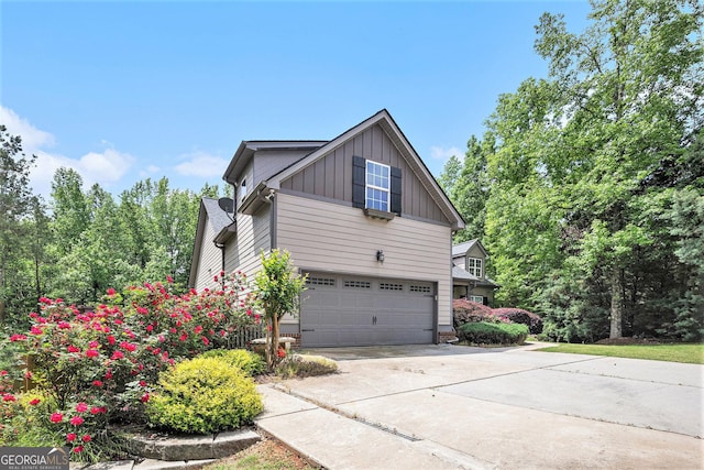 2753 Jubilee Ter, Bethlehem, GA 30620 - view of side of property with board and batten siding, driveway, and a garage
